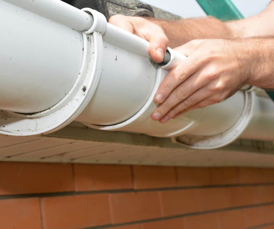 a hand installing gutters in a home