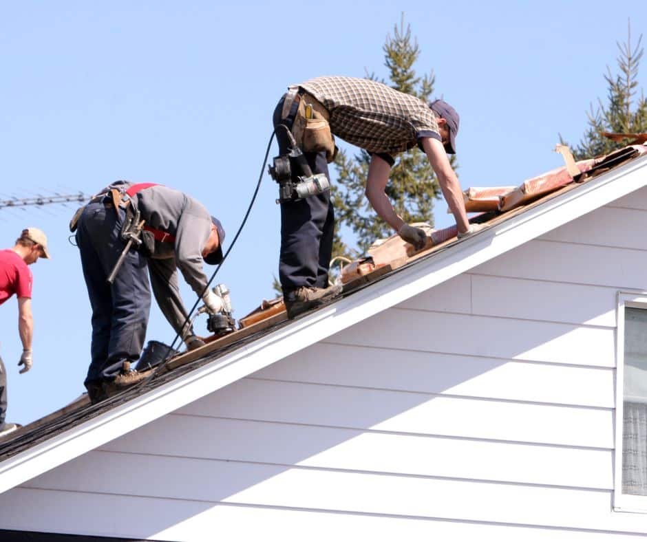 a group of men working on a commercial and residential roof
