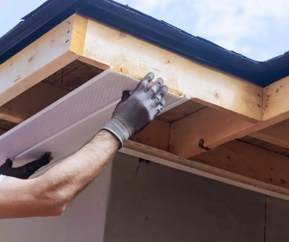 a person holding a soffit board