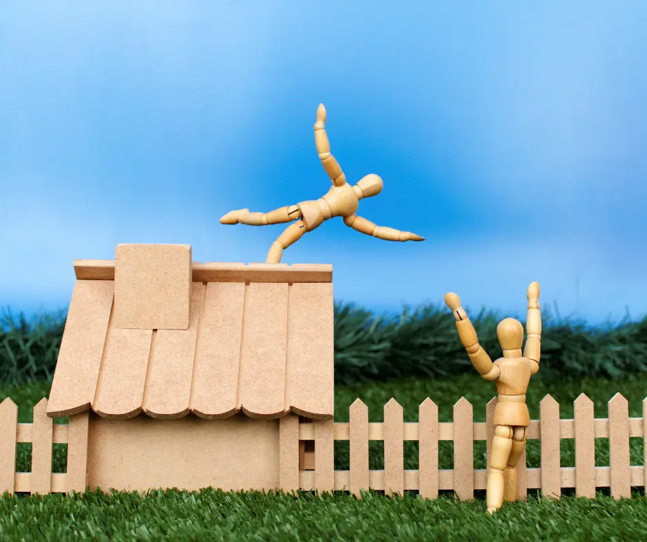 a wooden figures falling from the roof of a house