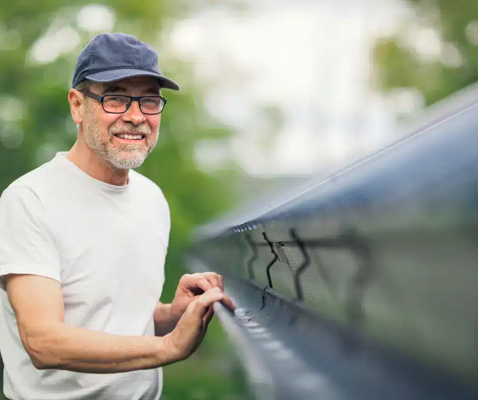 a WInnipeg homeowner smiling because of roof maintenance done properly