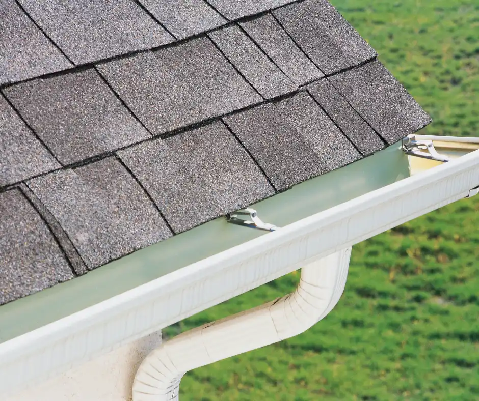 a roof gutter with a white gutter attached to it