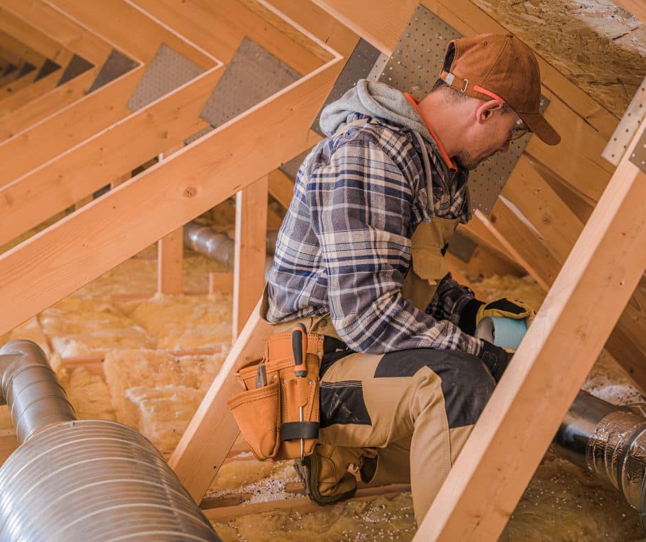 a man installing an insulation vacuum