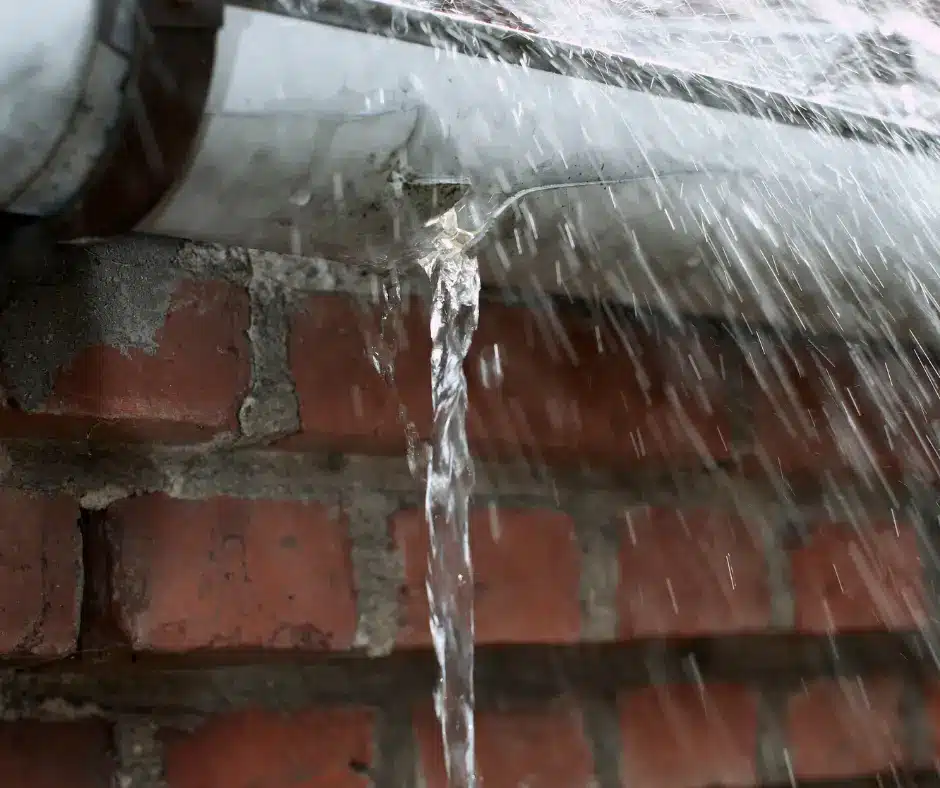 a rain gutter with water coming out of it