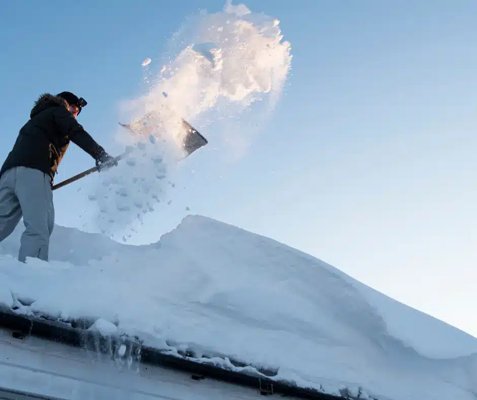 a winnipeg roofing experts showing how to safely remove snow from your winnipeg roof