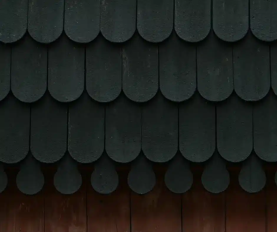 a black roof shingles on a wood surface