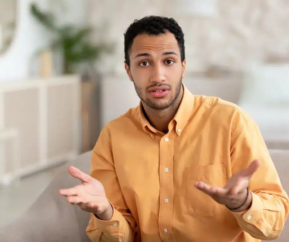 a man in a yellow shirt asking question