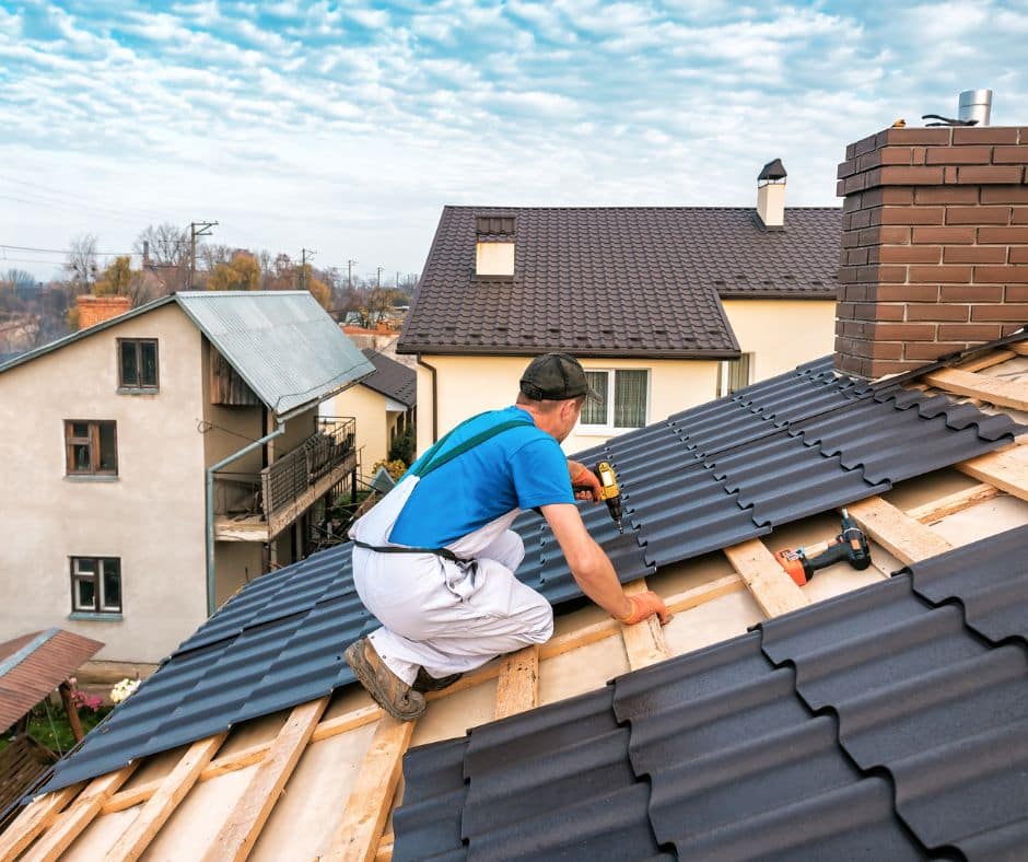 a roofer installing metal roofing in a Winnipeg home