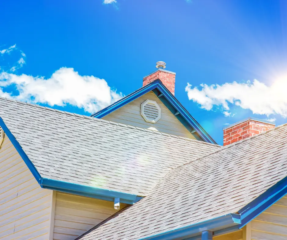 a composite roof of a house with a chimney