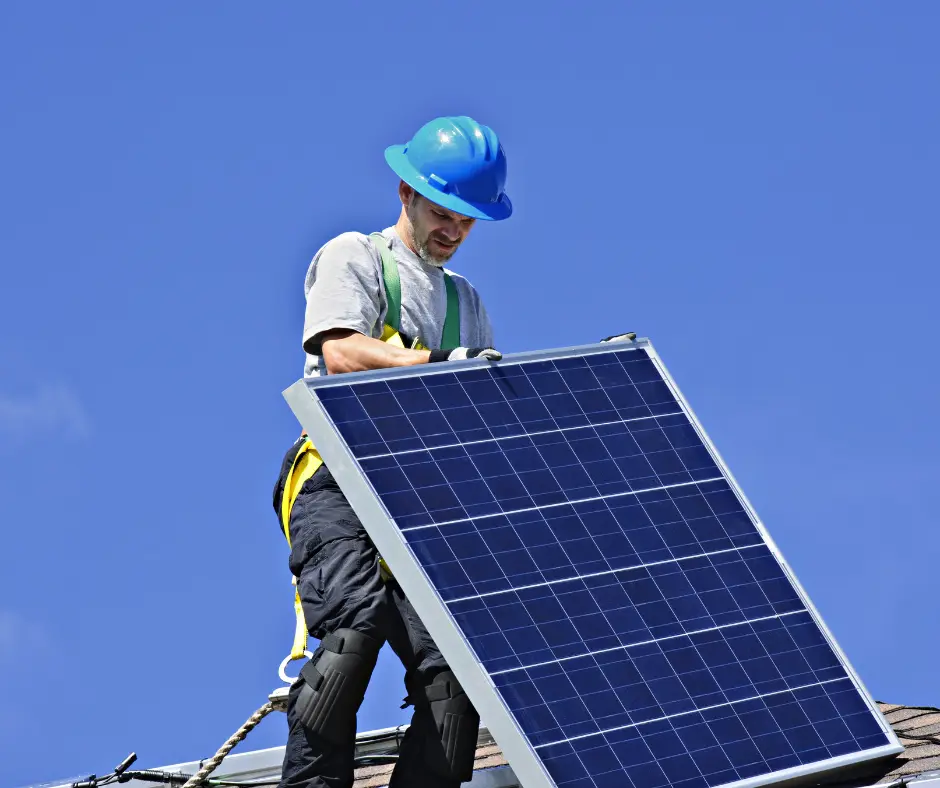 a man in a hard hat installing a solar panel