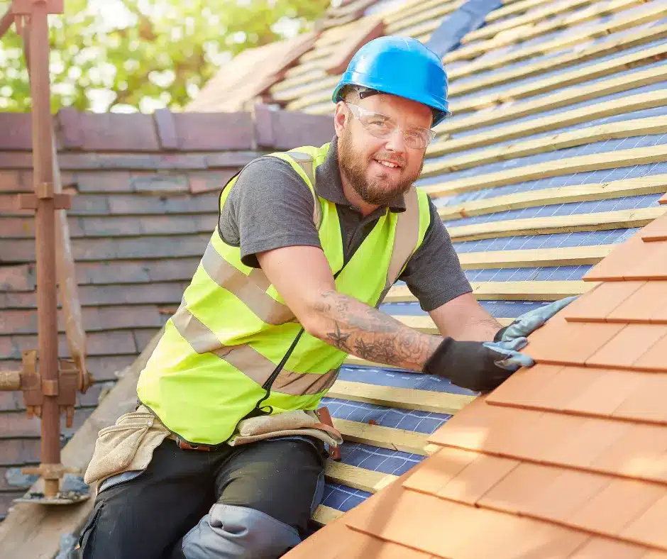 a man wearing a safety vest and gloves on a roof from roofing companies close to me