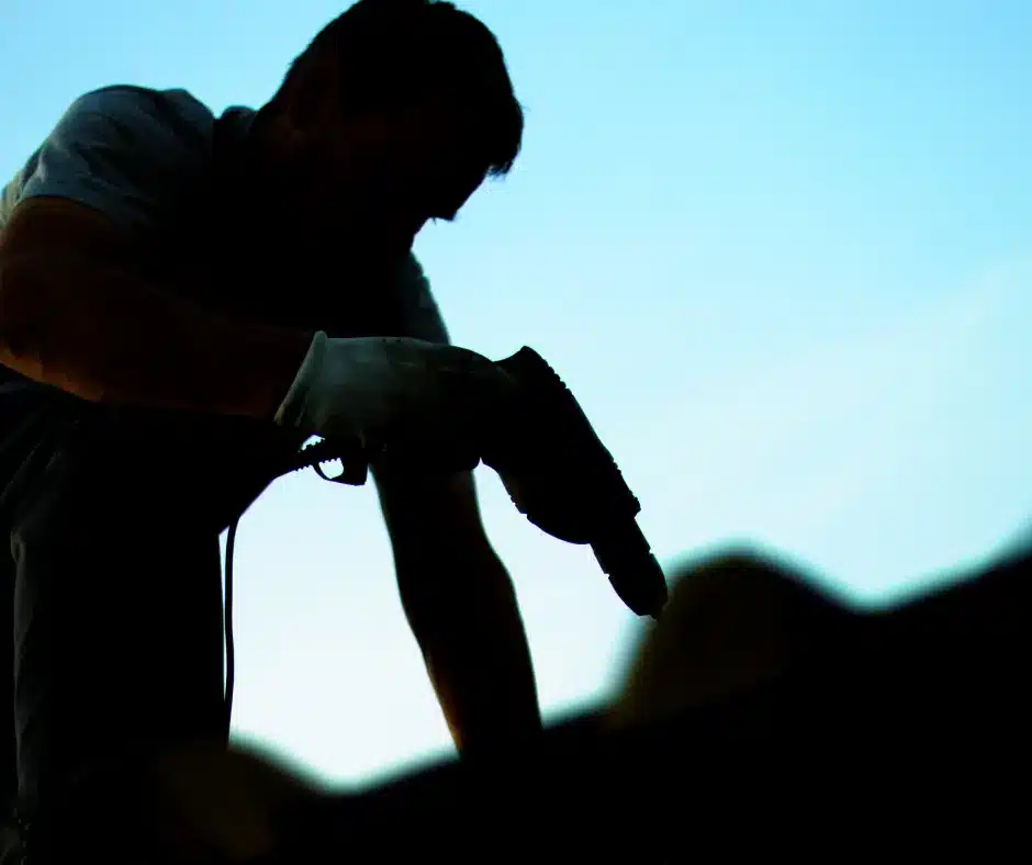 a silhouette of a winnipeg roofer on a roof