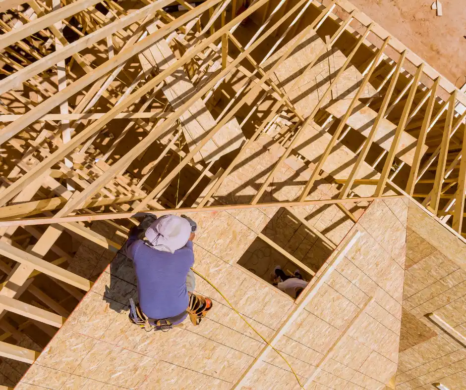 a man installing a roof deck