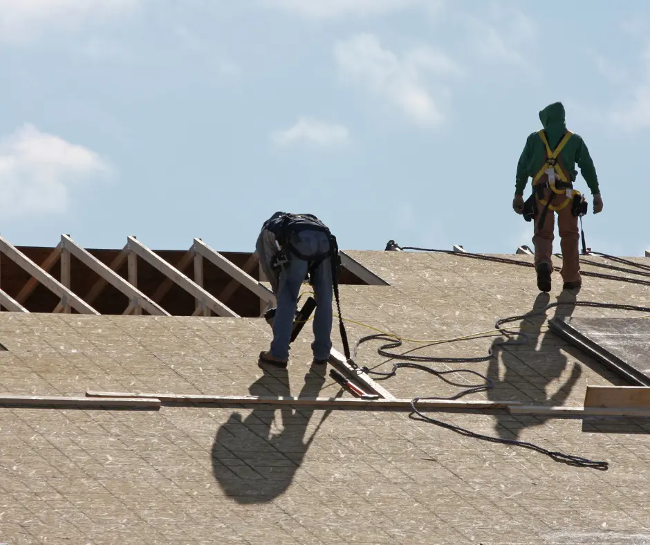 a group of people working on a roof with help of roof financing