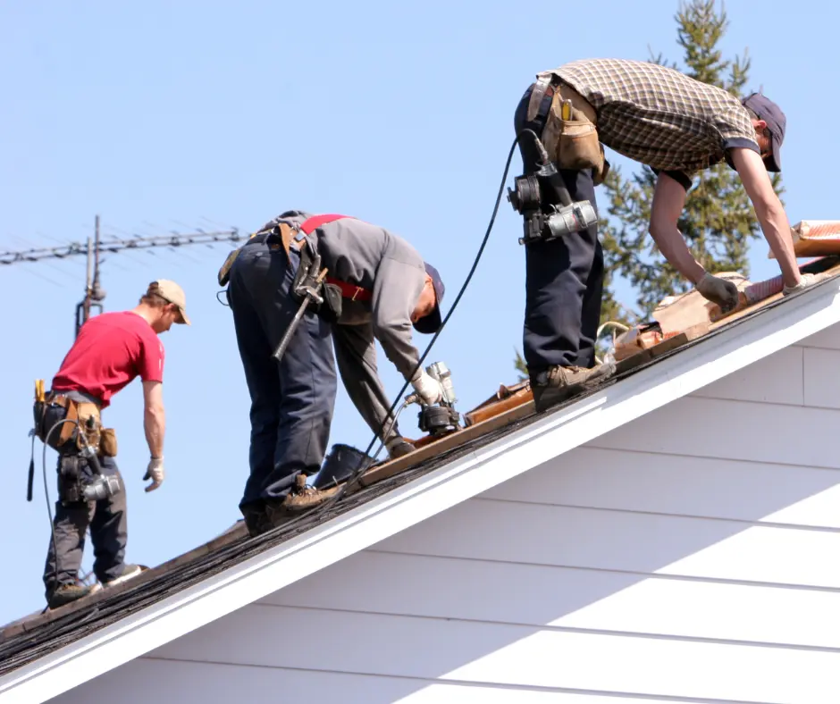 a group of men working on a roof 