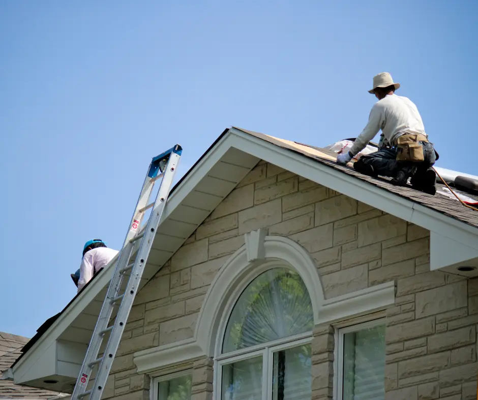 a group of men on a ladder on a roof providing residential roofing services