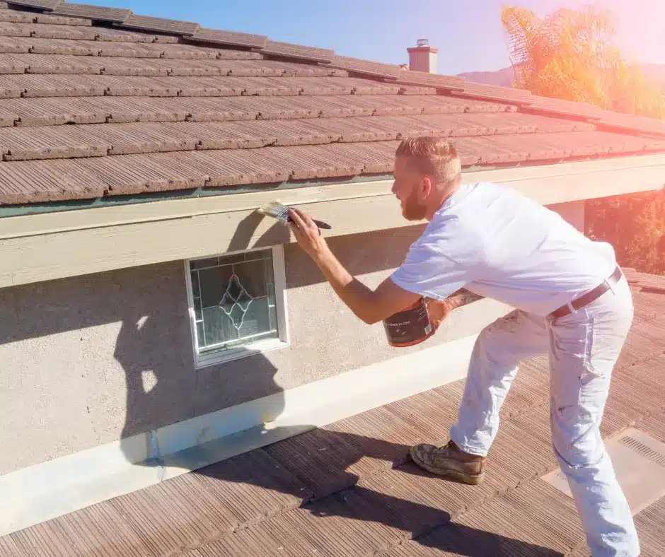 a man painting a  fascia roof