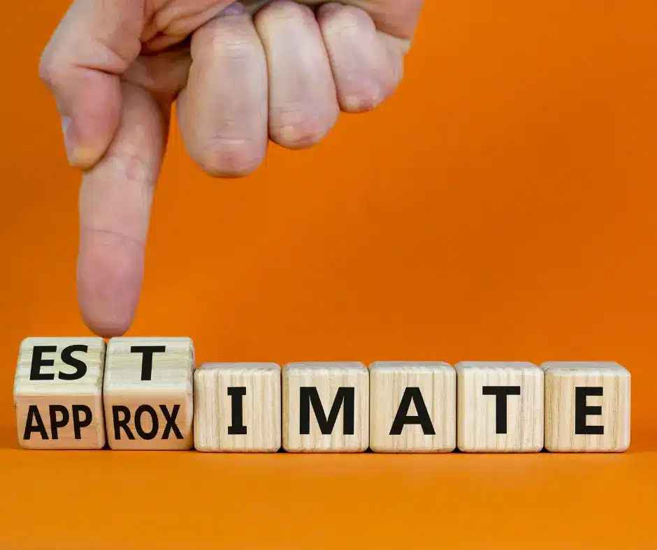 a finger pointing at wooden blocks with black letters spelled approximate and estimate