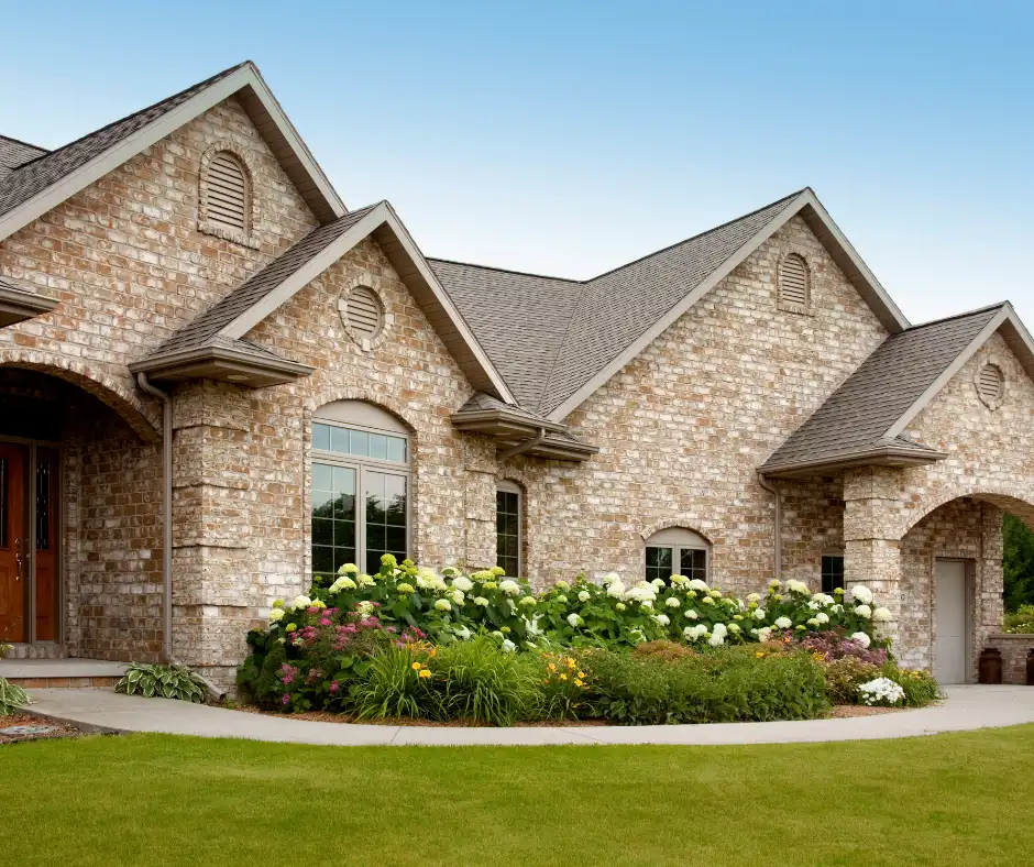 a house with a lawn and flowers and roof made from certainteed landmark shingles