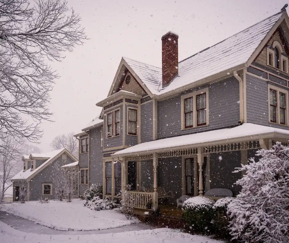 a house covered with snow from roof to the ground