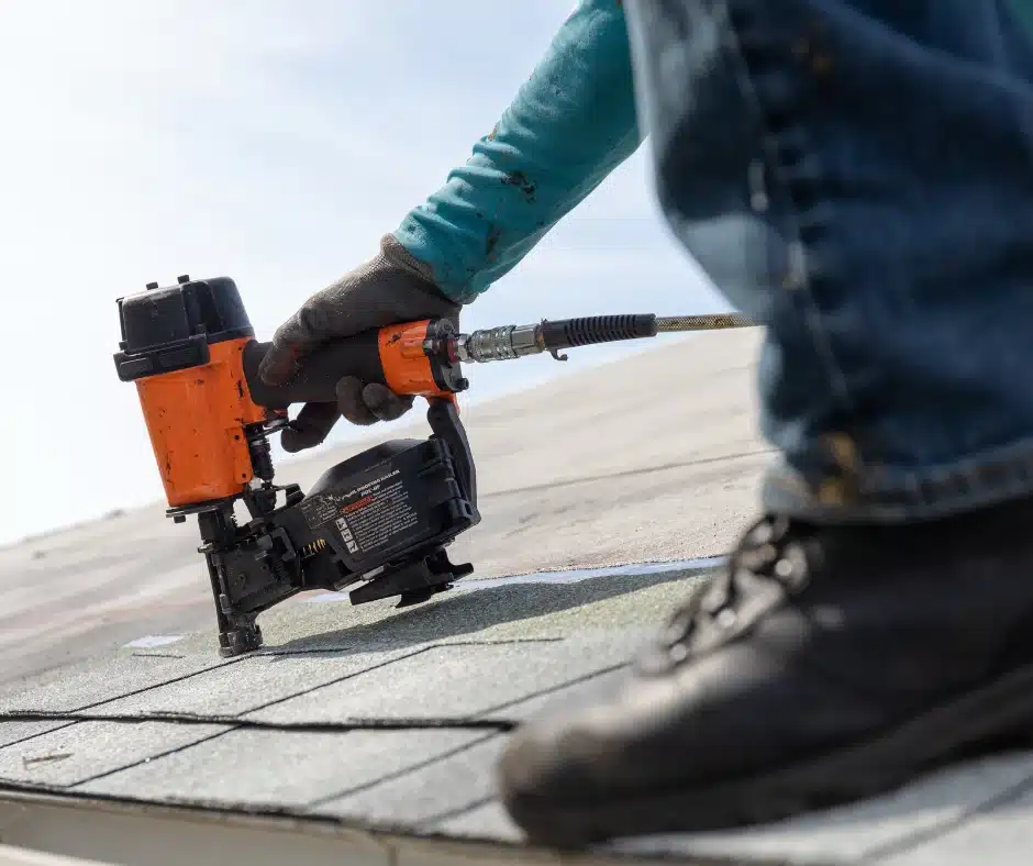 a person using a nail gun on a roof