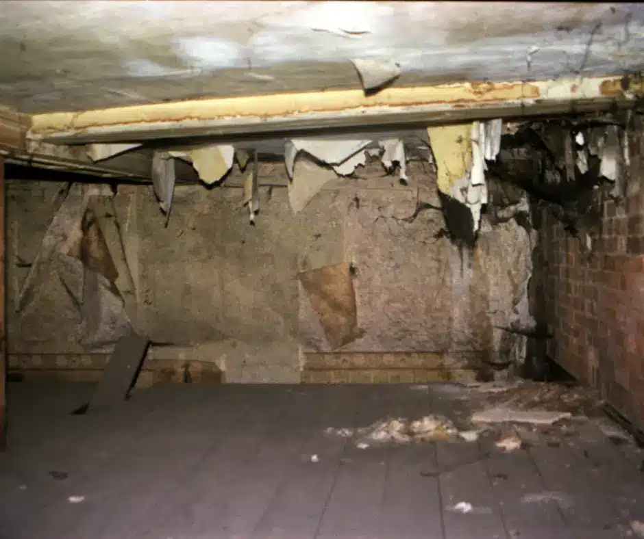 an attic room with a brick wall and ceiling