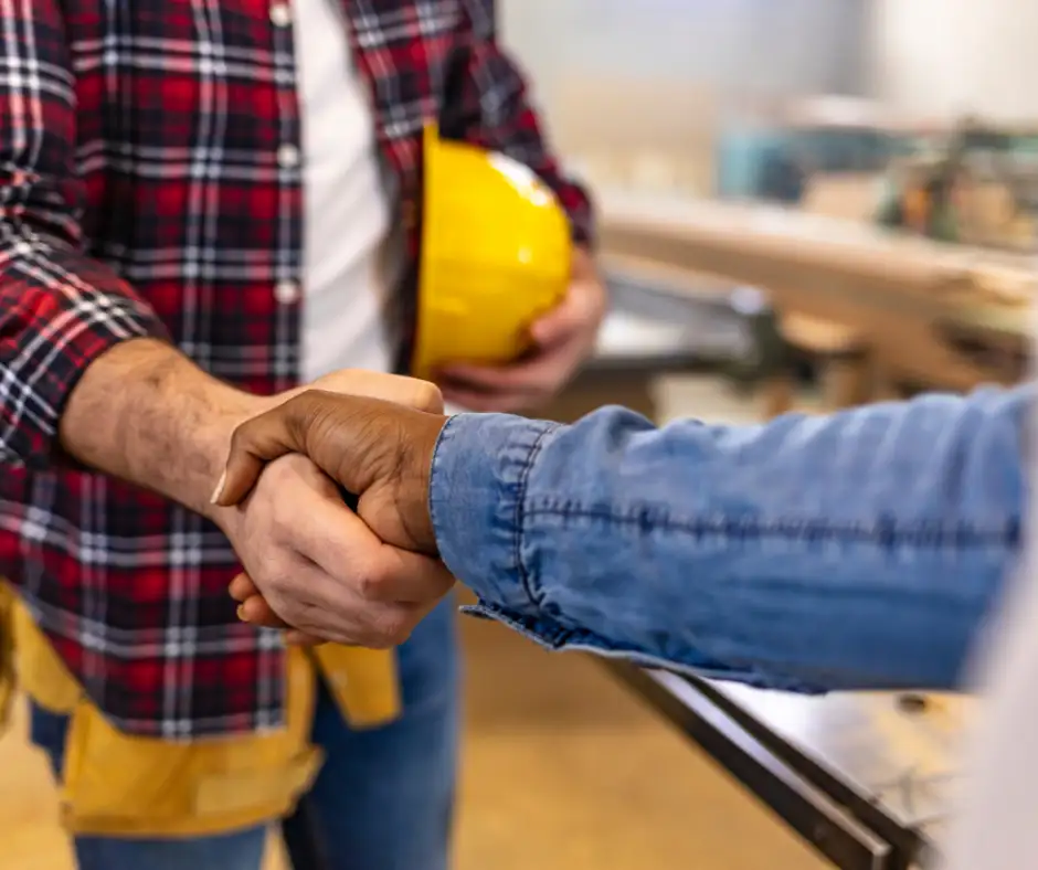 a close-up of a man shaking hands with a residential roofing contractors